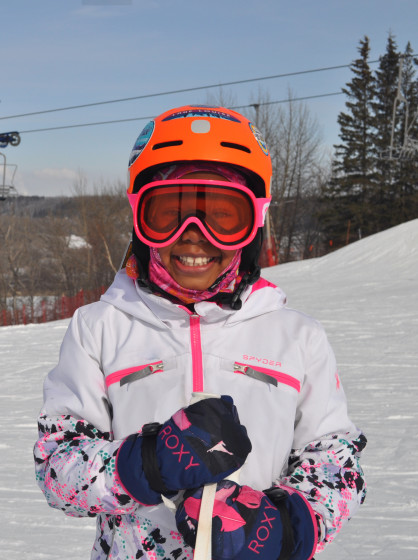smiling kid with ski equipment